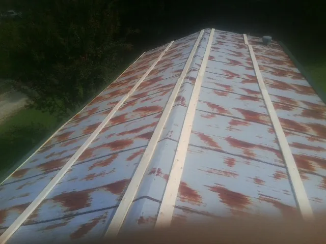 Rusted metal roof panels with new wood purlins before replacement — Storm Damage Roof Repair in Mars Hill by Roofing Brothers
